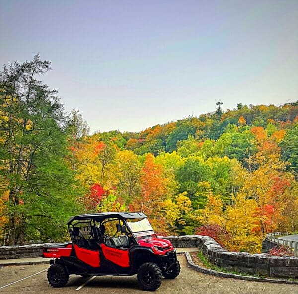 A red and black vehicle parked on top of a hill.