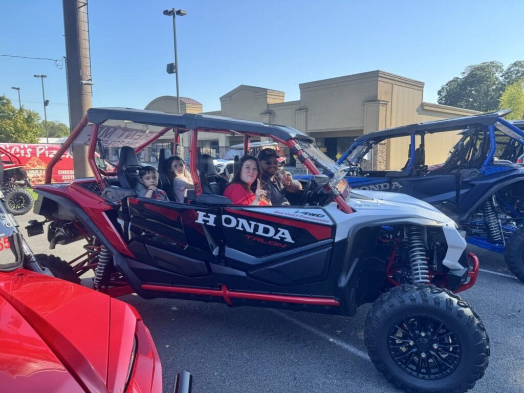 A couple and their kids in a UTV